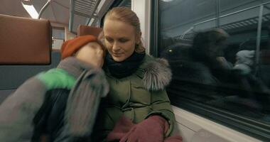 Mother and her gentle loving son traveling by train video