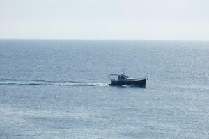 Fishing vessel returning from fishing in the Mediterranean Sea. photo