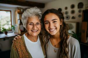 Smiling granddaughter and grandmother with tablet computer on couch at home enjoying family generation technology photo