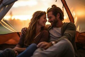 Happy couple picnicking in a tent at the riverside photo