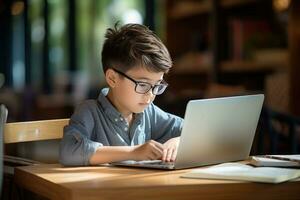 Boy studying with a laptop and notebook photo