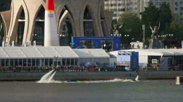 KAZAN, RUSSIAN FEDERATION, JUNE 15, 2019 - Time lapse, flyboarding entertainment for people at the air show in Kazan. Spectators on the embankment, extreme flight over water video