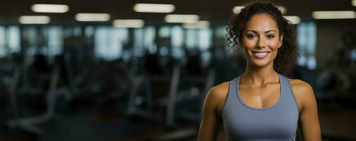 Smiling woman hands on hip stands at the gym photo