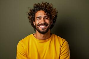 Handsome man with curly hair happily poses against brown background photo