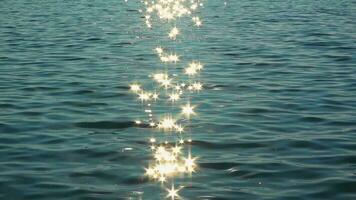 Shiny sparkles from sun reflection over ocean water surface footage. video