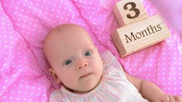 Three months baby girl in pink bassinet video