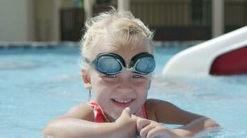 Summer portrait of cheerful girl toddler in the pool video