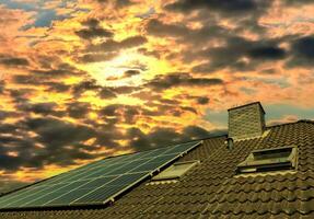 Solar panels producing clean energy on a roof of a residential house photo
