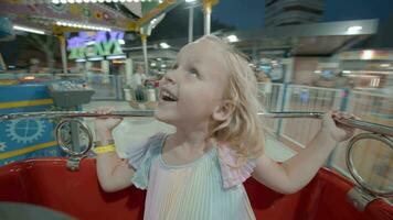 Delighted child in merry-go-round at night video