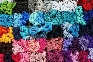 Detailed close up view on samples of cloth and fabrics in different colors found at a fabrics market photo