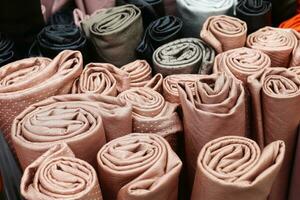 Detailed close up view on samples of cloth and fabrics in different colors found at a fabrics market photo