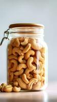 Cashew nuts in a glass jar on a white background AI Generated photo