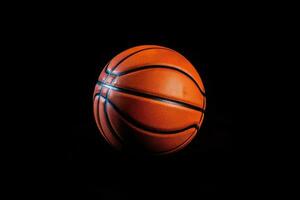 a basketball ball is sitting on a black surface AI Generated photo