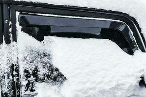 Car in winter in the snow, Cleaning the car photo