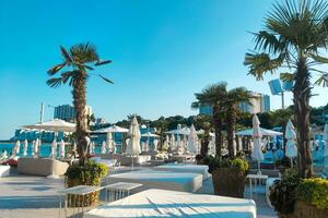 Beach line for relaxation with sun loungers and umbrellas photo