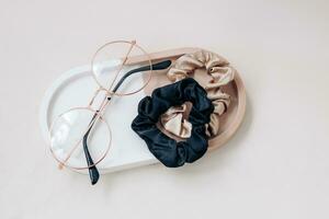 Glasses with silk elastic bands in plaster organizer photo