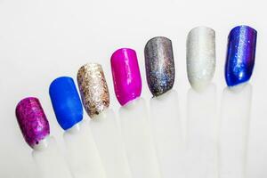 Palette of nail designs, testers of multicolored polishes on flat nails photo