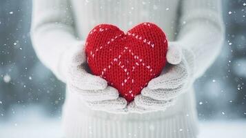 Female hands in mittens holding red heart on snowy winter background. Generative AI photo