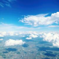 Panoramic view of fields and clouds from an airplane window. The sky is a bright blue with fluffy white clouds. Generative AI photo