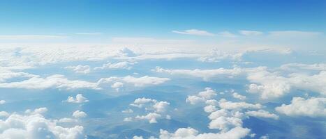 Panoramic view of fields and clouds from an airplane window. The sky is a bright blue with fluffy white clouds. Generative AI photo