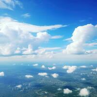 Panoramic view of fields and clouds from an airplane window. The sky is a bright blue with fluffy white clouds. Generative AI photo