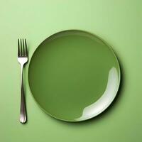 Minimalistic green ceramic plate with metal fork and knife. Top view. Highresolution. Ai generative photo