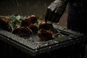 closeup of a funeral casket at a cemetery with flowers in the rain,hand on the grave in the rain with dark background and rose AI generated photo