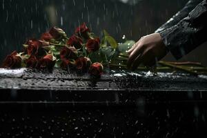 closeup of a funeral casket at a cemetery with flowers in the rain,hand on the grave in the rain with dark background and rose AI generated photo