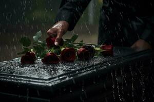 de cerca de un funeral ataúd a un cementerio con flores en el lluvia, mano en el tumba en el lluvia con oscuro antecedentes y Rosa ai generado foto