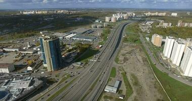 Aerial view of city edge with wide highway and residential districts video