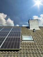 Solar panels producing clean energy on a roof of a residential house photo