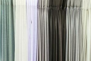 Detailed close up view on samples of cloth and fabrics in different colors found at a fabrics market photo