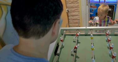 Father and Son Playing Foosball in Arcade video