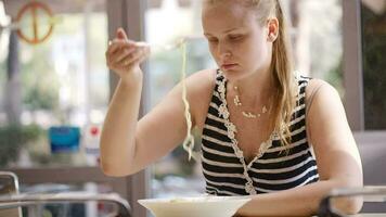 Young woman eating spaghetti video