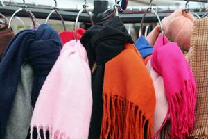 Detailed close up view on samples of cloth and fabrics in different colors found at a fabrics market photo