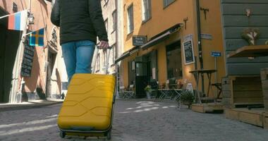 Back View Of A Traveling Man Walking With Suitcase video