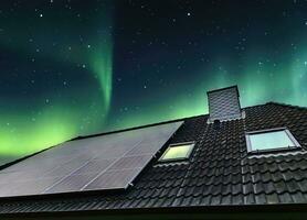 Solar panels producing clean energy on a roof of a residential house photo