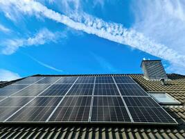 Solar panels producing clean energy on a roof of a residential house photo