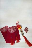 Chinese new year decorations and gold ingots or golden lump on wooden background. photo