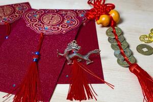 Chinese new year decorations and gold ingots or golden lump on wooden background. photo