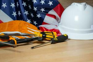 blanco casco y herramientas en grande americano bandera, labor día antecedentes. foto