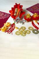 Chinese new year decorations and gold ingots or golden lump on wooden background. photo