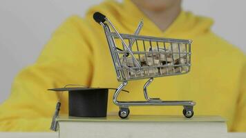 a person holding a shopping cart with a graduation cap on top video