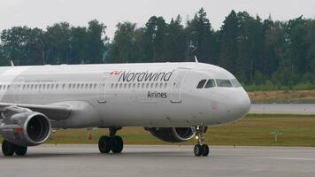 MOSCOW, RUSSIAN FEDERATION JULY 29, 2021 - Side view, airplane Airbus A321, VQBOD of Nordwind Airlines taxiing at Sheremetyevo airport. Aircraft on the taxiway. Commercial jet on the airfield video