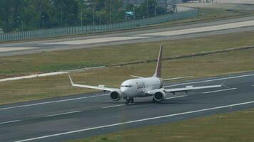 PHUKET, THAILAND FEBRUARY 03, 2023 - Boeing 737 MAX, 9MLRD of Batik Air Malaysia arriving at Phuket Airport, side view. Passenger flight on runway. Tourism and travel concept video