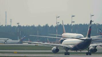 Widebody airliner accelerate before departure, Moscow airport. Airplane on runway. Airfield, avia traffic video