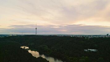 The city hides behind the woods and river of the city park video