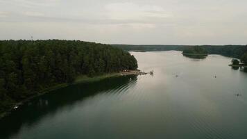 Flyover of the Forest Lake, Marina and beach. Asveja is the longest lake in Lithuania video