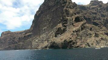 The mighty cliffs of Los Gigantes of Tenerife viewed from a swaying boot. video