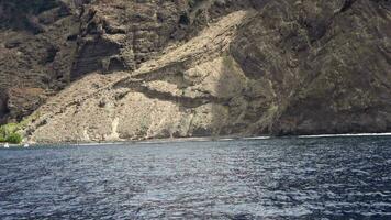 The mighty cliffs of Los Gigantes of Tenerife viewed from a swaying boot. video